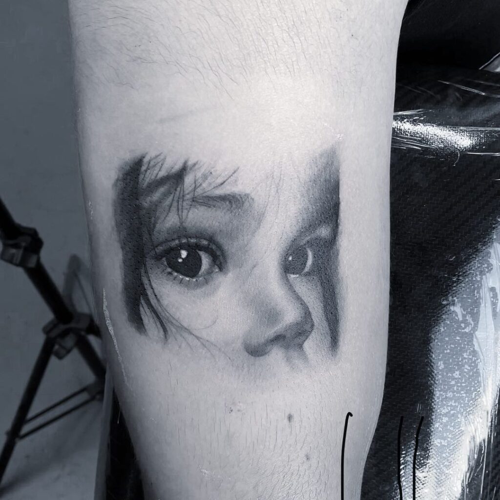 Tatuaje con tinta blanca y negro, de la mirada de una niña.